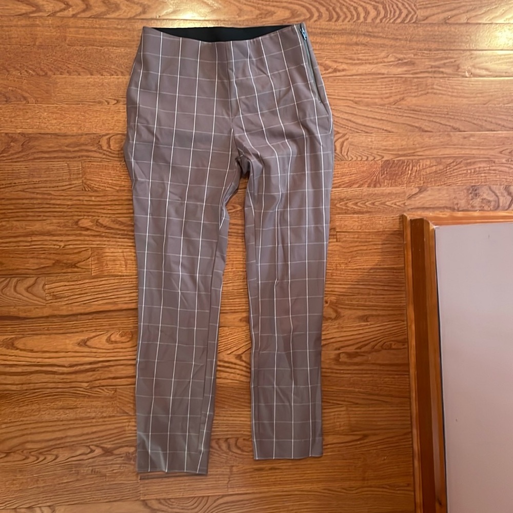 Brown dress pants. Elastic waste and side zipper. Faux back pockets.